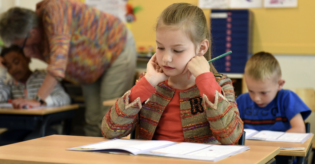 young-girl-at-a-desk-working-on-an-assignment