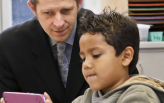 superintendent-with-a-student-looking-at-ipad