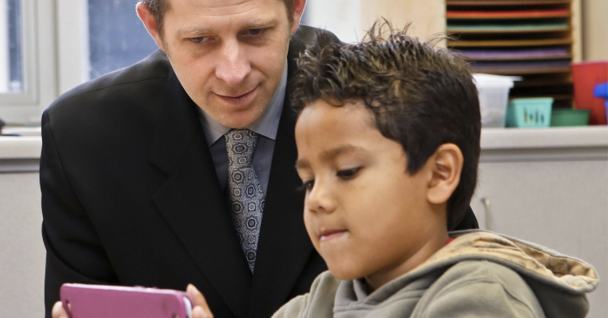 superintendent-with-a-student-looking-at-ipad
