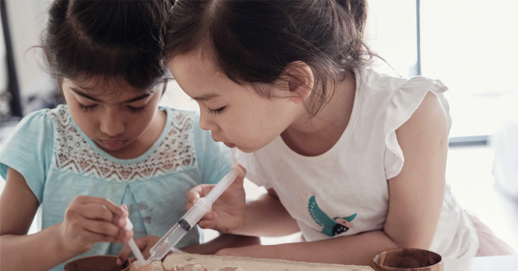 two-young-girls-concentrating-on-a-project