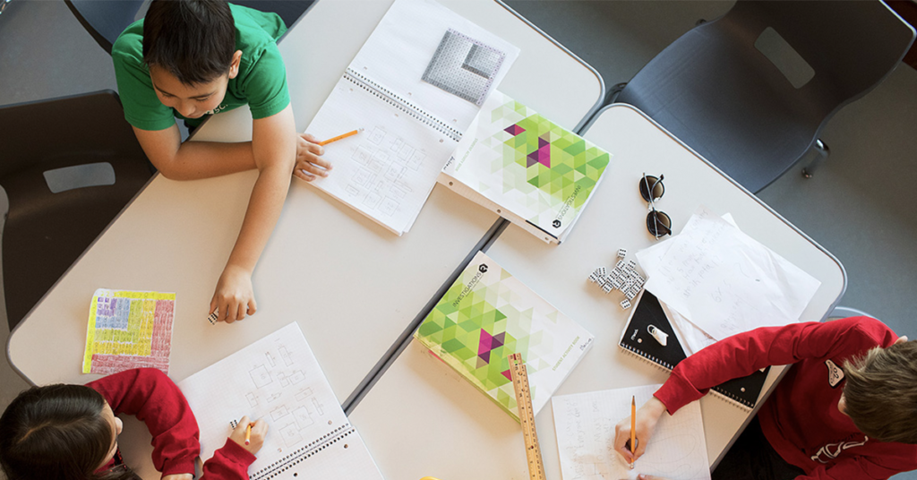 three-children-collaborating-at-a-table